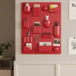 White desk organizer shelf with books and office supplies on a wooden desk