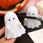 Side view of the ghost pen holder next to a laptop on an office desk.