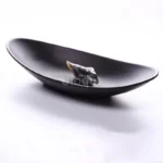 Black melamine dinner plates stacked elegantly on a wooden table