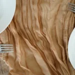 Rustic cheesecloth table runner on wooden table with boho decor
