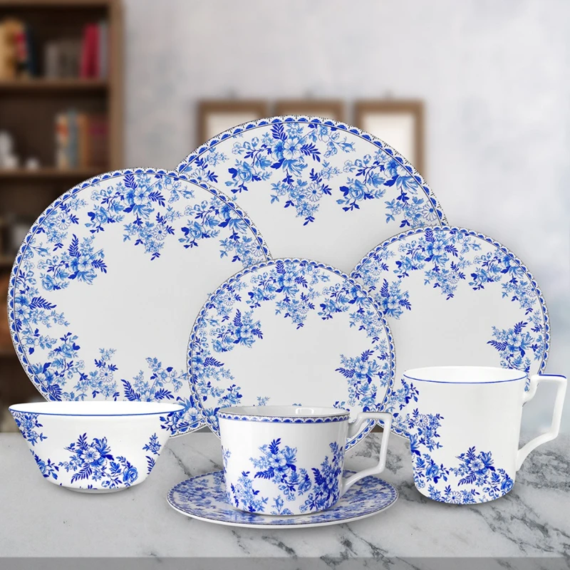 Vintage blue and white bone china dinnerware plate set on wooden table