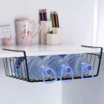 Metal under shelf basket hanging from a kitchen shelf, holding spices and small jars