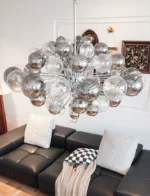 Smoky gray chandelier with glass bubbles hanging over a modern dining table