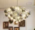 Smoky gray chandelier with glass bubbles hanging over a modern dining table