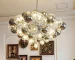 Smoky gray chandelier with glass bubbles hanging over a modern dining table