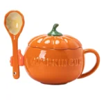 Colorful ceramic novelty mug shaped like a pumpkin, tomato, and avocado on a wooden table
