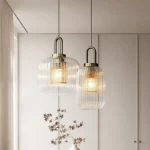 Japanese style glass pendant light in a kitchen island setting, with warm light casting soft shadows.