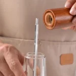 Manual pepper grinder with acrylic body and ceramic core on kitchen counter