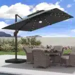 Goldoma large patio umbrella with lights illuminating a 9x9 FT square cantilever umbrella with solar LED lights in a bac
