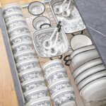Elegant 20-piece porcelain dinnerware set arranged on a table, showcasing bowls and plates in a gift box