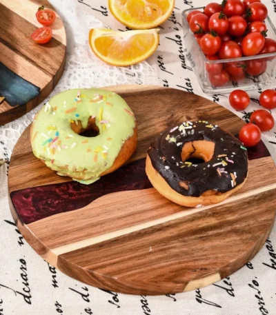 Round acacia cutting board with resin inlay on kitchen counter