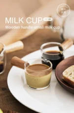 Clear espresso shot glass with handle on wooden surface