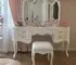 Goldoma white vanity table with mirror and stool in a modern bedroom setting
