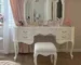 Goldoma white vanity table with mirror and stool in a modern bedroom setting