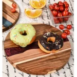 Round acacia cutting board with resin inlay on kitchen counter