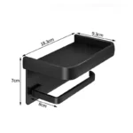 Toilet paper holder on dark wall, contrasting with silver finish and white roll.