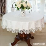Elegant lace tablecloth with rose gold embroidery on a dining table