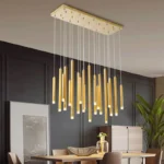 Geometric gold chandelier with crystal accents in a modern dining room setting.