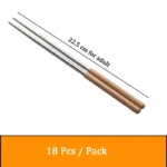 Stainless steel flatware set with wooden handles displayed on a table
