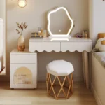 Modern makeup vanity desk with mirror and stool in a bedroom setting, showcasing ample storage and elegant design