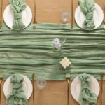Boho cheesecloth table runner and napkins set as rustic table linens on a wooden table
