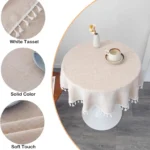 Round linen tablecloth with tassels on a dining table