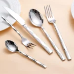 Luxury stainless steel flatware set with diamond 3D texture on a wooden table