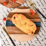 Round acacia cutting board with resin inlay on kitchen counter