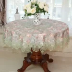 Elegant lace tablecloth with rose gold embroidery on a dining table