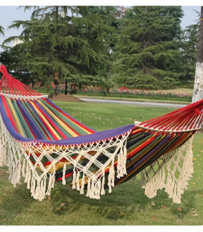 Bohemian double hammock with tassels in garden