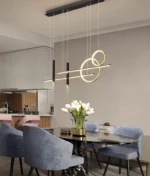 Modern pendant light with a gold interior and black exterior in a living room.