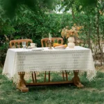 Retro polka dot tablecloth with fringe on a wooden table