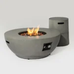 50,000 BTU fire pit table with grey steel finish and propane tank holder on a patio