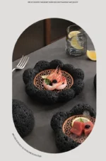 Volcanic stone sushi plate with fresh sushi rolls and wasabi on a dark textured surface