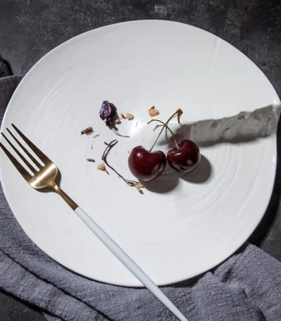 Hexagonal dinner plate with Japanese-inspired ceramic design on a wooden table