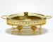 Elegant gold oval buffet food warmer with glass lid on buffet table