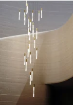 Overhead view of the pendant light above a glass dining table.