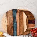 Round acacia cutting board with resin inlay on kitchen counter