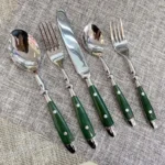 Elegant stainless steel cutlery set with fork, knife, and spoon on a wooden table
