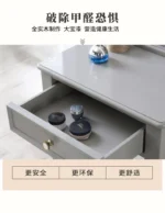 Modern white dressing table with mirror and stool in a bedroom setting