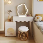 Modern makeup vanity desk with mirror and stool in a bedroom setting, showcasing ample storage and elegant design