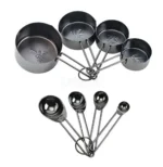 Set of stainless steel measuring cups with copper and rose gold finishes on wooden stand
