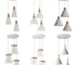 Modern pendant light with three white wood-aluminum shades hanging over a dining table