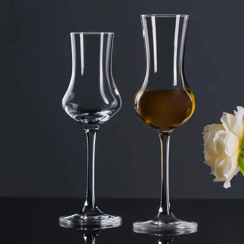 Elegant lead-free whisky tasting glass on a wooden table, highlighting the crystal-clear design and aroma-enhancing shap
