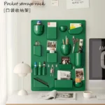 White desk organizer shelf with books and office supplies on a wooden desk