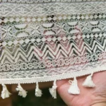 Retro polka dot tablecloth with fringe on a wooden table