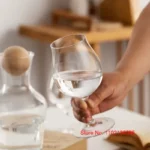Kimura Shouko ultra thin wine glass on a wooden table, catching light