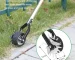 Goldoma manual lawn trimmer with sharp stainless steel blade, angled for precise cutting on green grass.