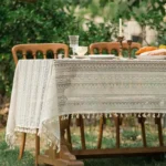 Retro polka dot tablecloth with fringe on a wooden table