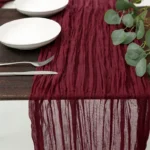 Rustic cheesecloth table runner on wooden table with boho decor